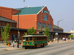 Trolley passing tourists in front of Louisville Slugger Field.