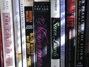 close up image of several paperback books on a shelf