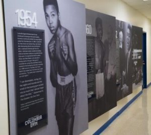 Photo panels displaying the history of Muhammad Ali's red bike story and his ties to Spalding.