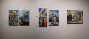 Various colorful collages, paintings and drawings, mostly of images of women, hanging on a white wall at the Huff Gallery