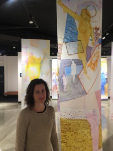 KyCAD professor Skylar Smith beside one of her long banner paintings for "Personal is Still Political"