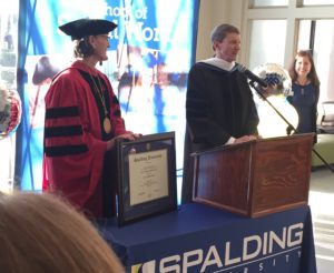 Spalding President Tori Murden McClure presents framed honorary doctorate diploma to Rep. Jim Wayne