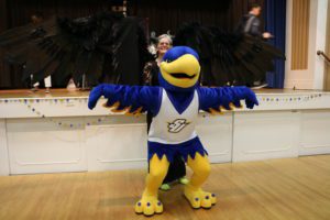 The Spalding blue and gold eagle mascot spreads his wings (arms) while President Tori McClure spreads the wings on her black Malificent costume