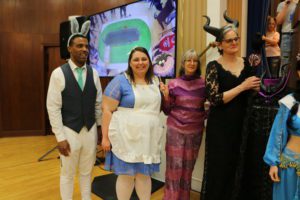 Four students and faculty wear Disney-themed costumes