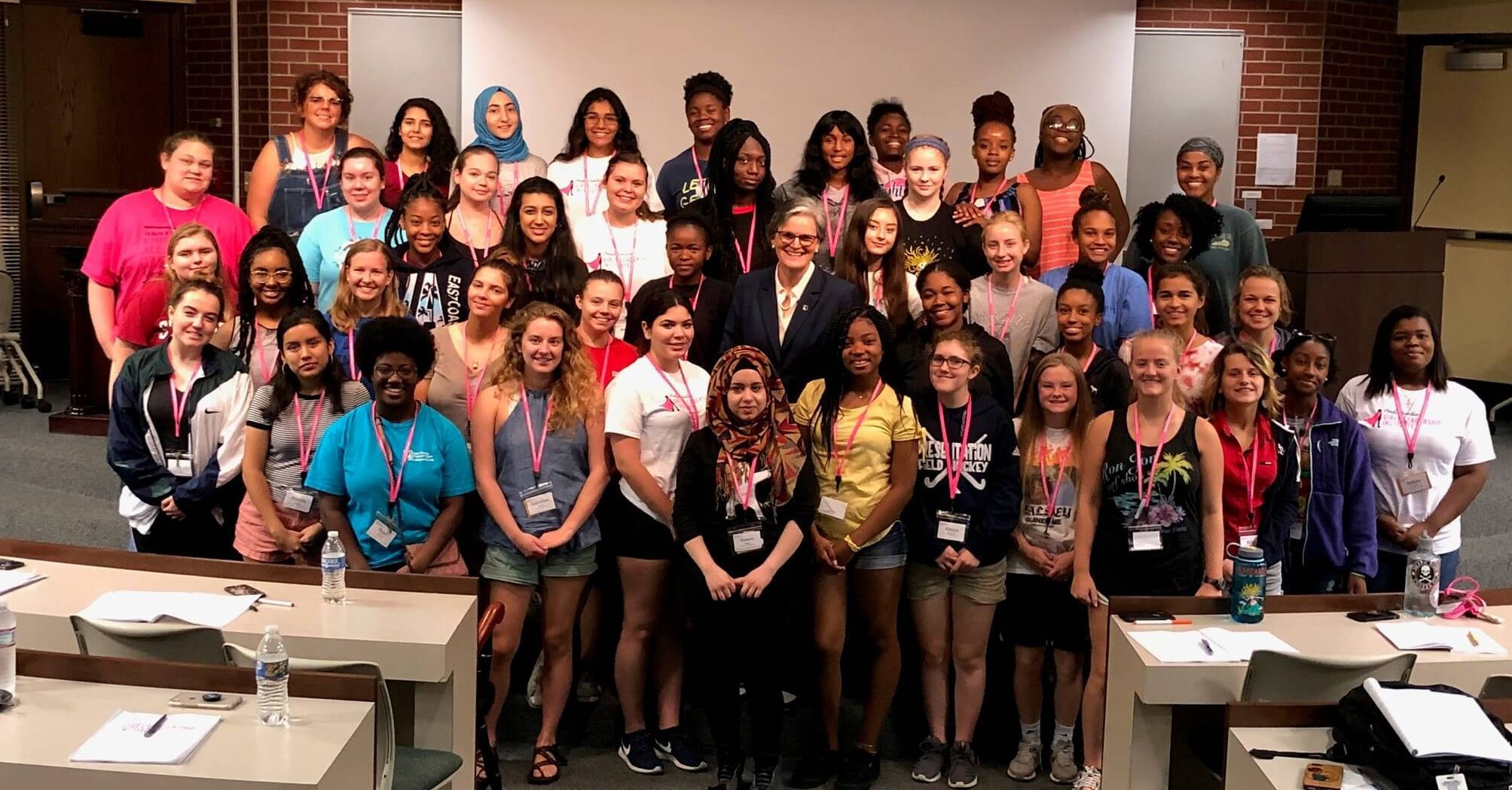 group about 40 teenage girls pose with Spalding President Tori Murden McClure