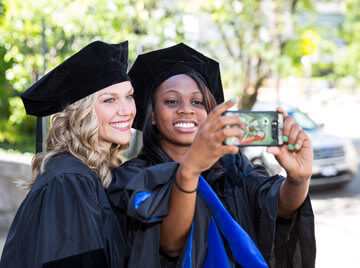 Students take selfie at graduation