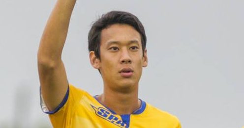 Spalding soccer player Tenko Kono, yellow shirt, blue shorts, waves to acknowledge the crowd during starting lineups