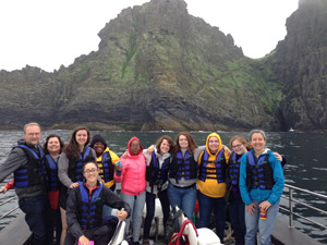 Spalding students on boat tour of Ireland with cliffs in background