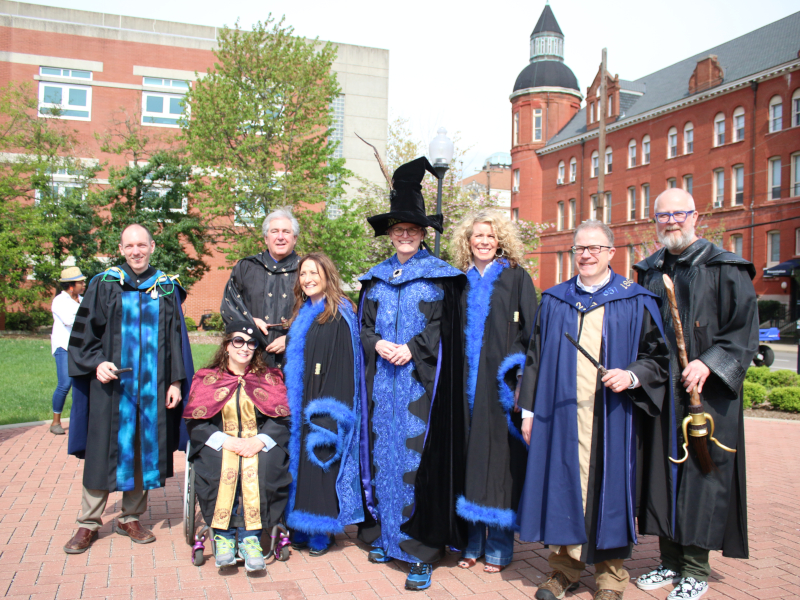 Members of Spalding Leadership Team wearing black Harry Potter-themed robes in Mother Catherine Square before the Rat Race parade.