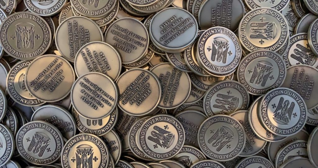 A large pile of bronze Spalding University mission coins