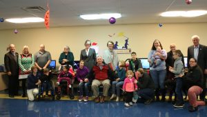 Spalding, Kosair Charities and enTECH officials posed families at enTECH