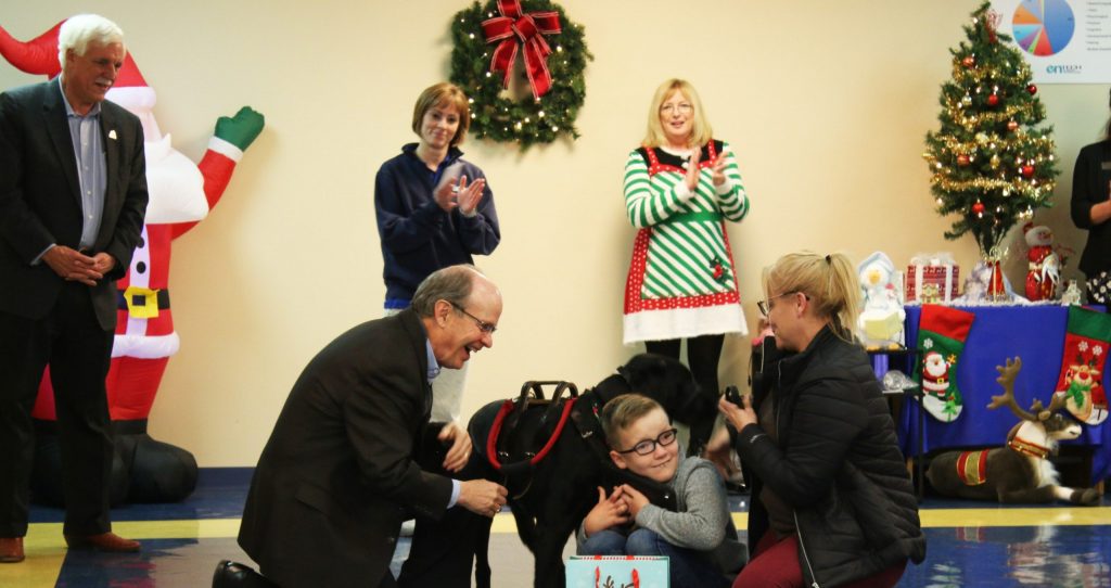 Kosair Charities President Keith Inman presents a gift to a young boy and his mom at enTECH
