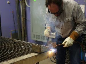 Shawn Hennessey welds in the Spalding Makerspace