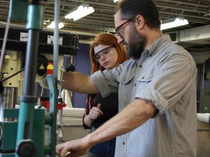 Spalding professor and student in the woodshop of the Spalding Makerspace