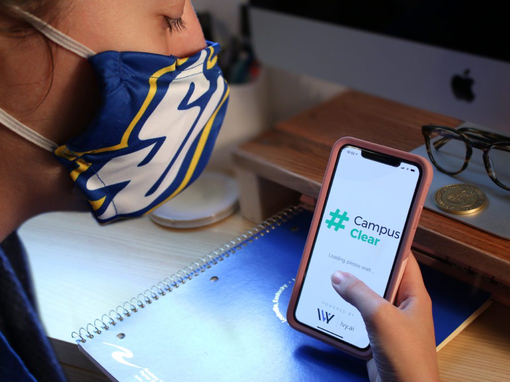 student wearing mask using #campusclear app