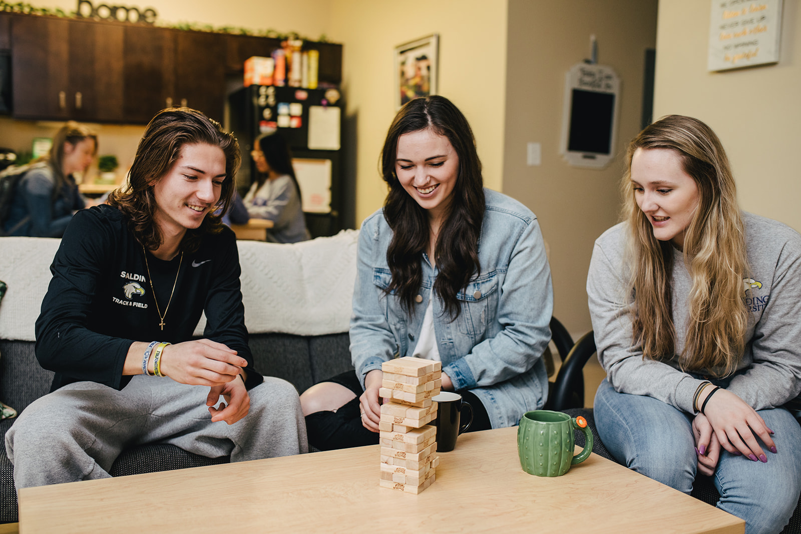 Students play tower game in Spalding Suites residence hall.