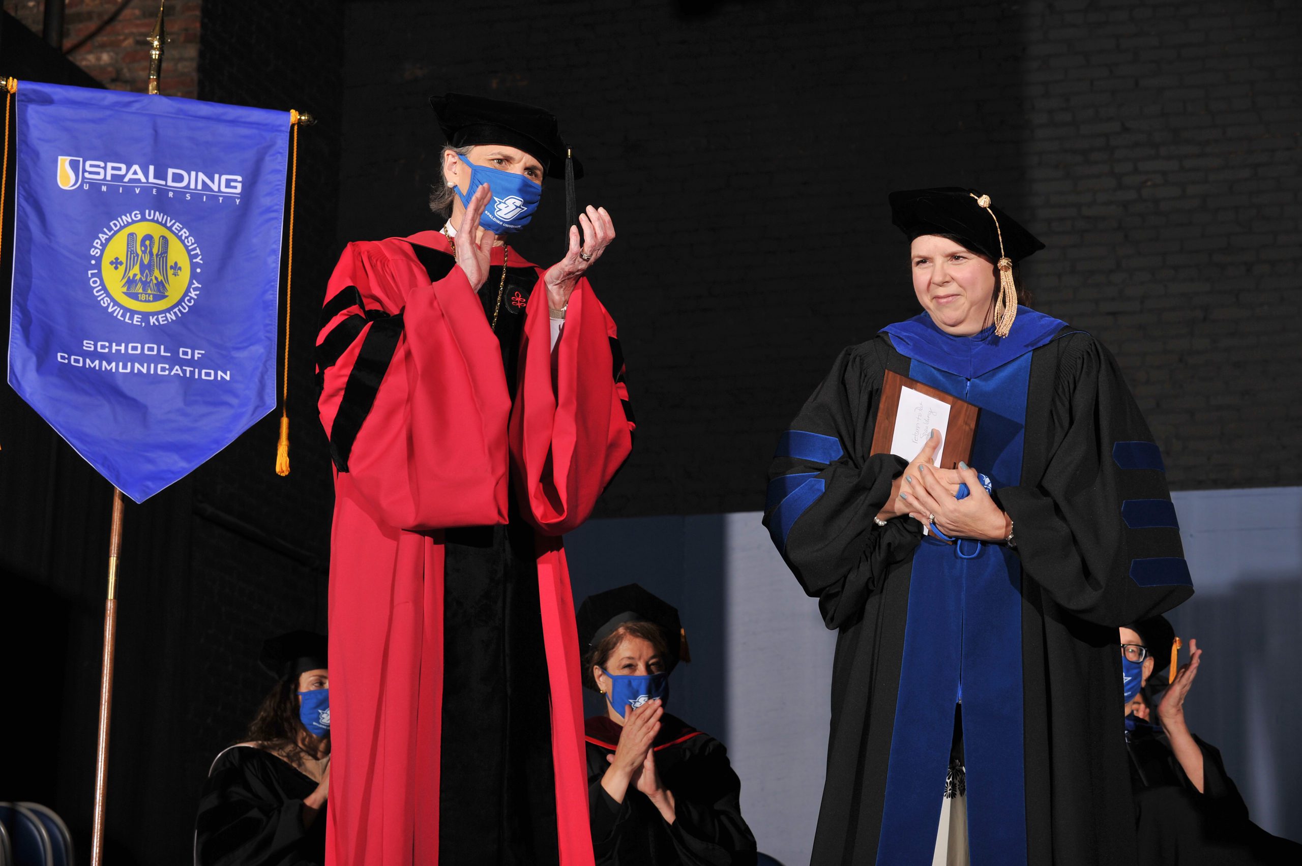Donna Elkins accepts Outstanding Faculty Award from President Tori Murden McClure at Commencement