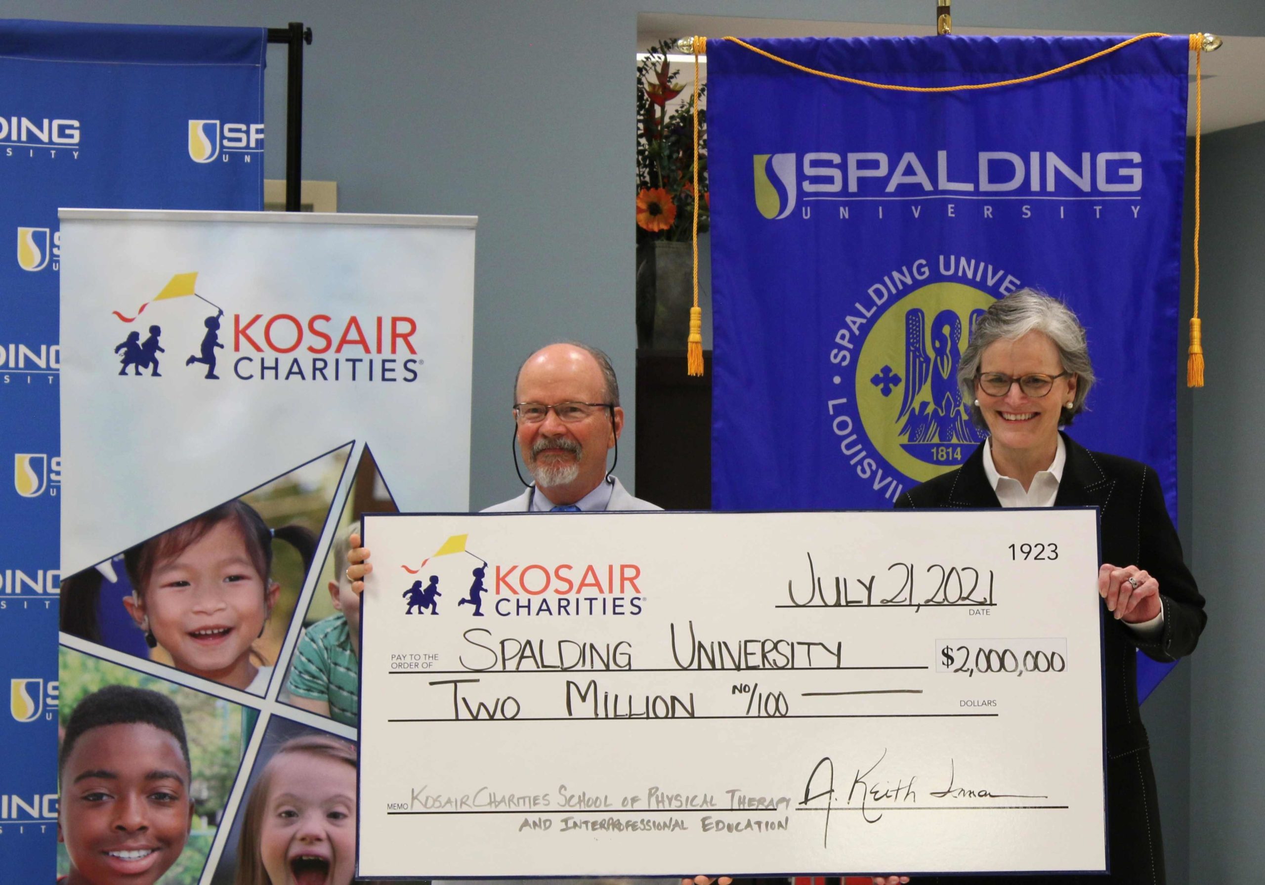 Spalding's Tori McClure receives $2 million grant check from Keith Inman of Kosair Charities