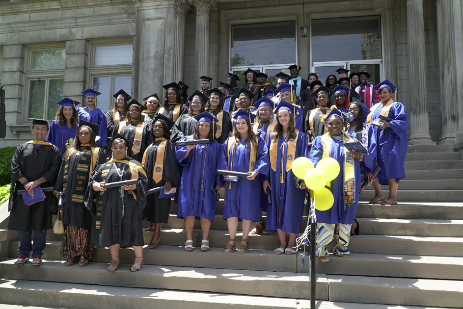 Large groups of Spalding grads assembled on Columbia Gym main entrance for photo
