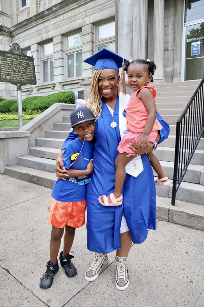 Spalding grad with her kids outside Columbia Gym