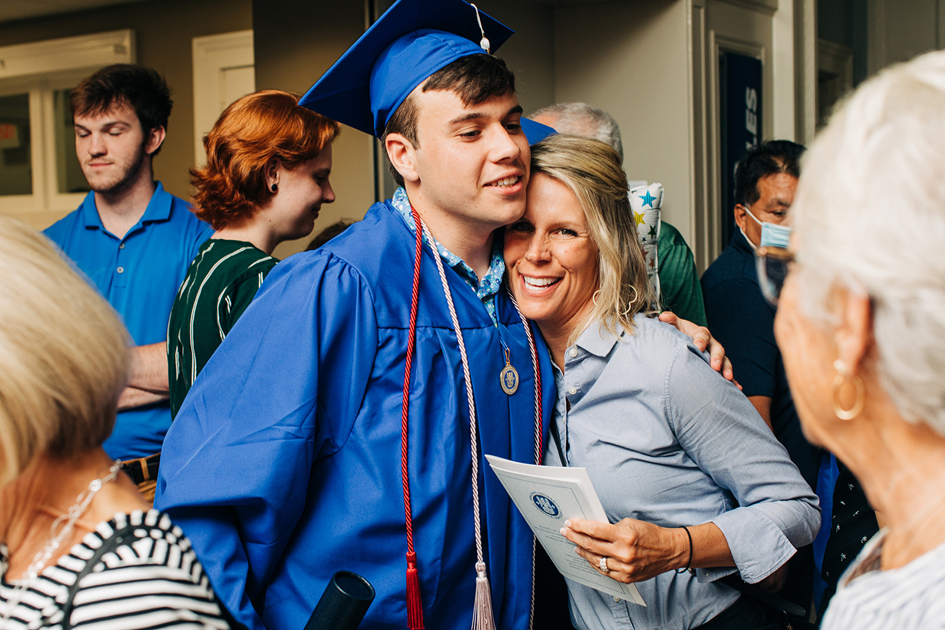 Spalding grad hugging his mom