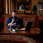 Spalding MFA Student in Brown Hotel holding pen and notepad