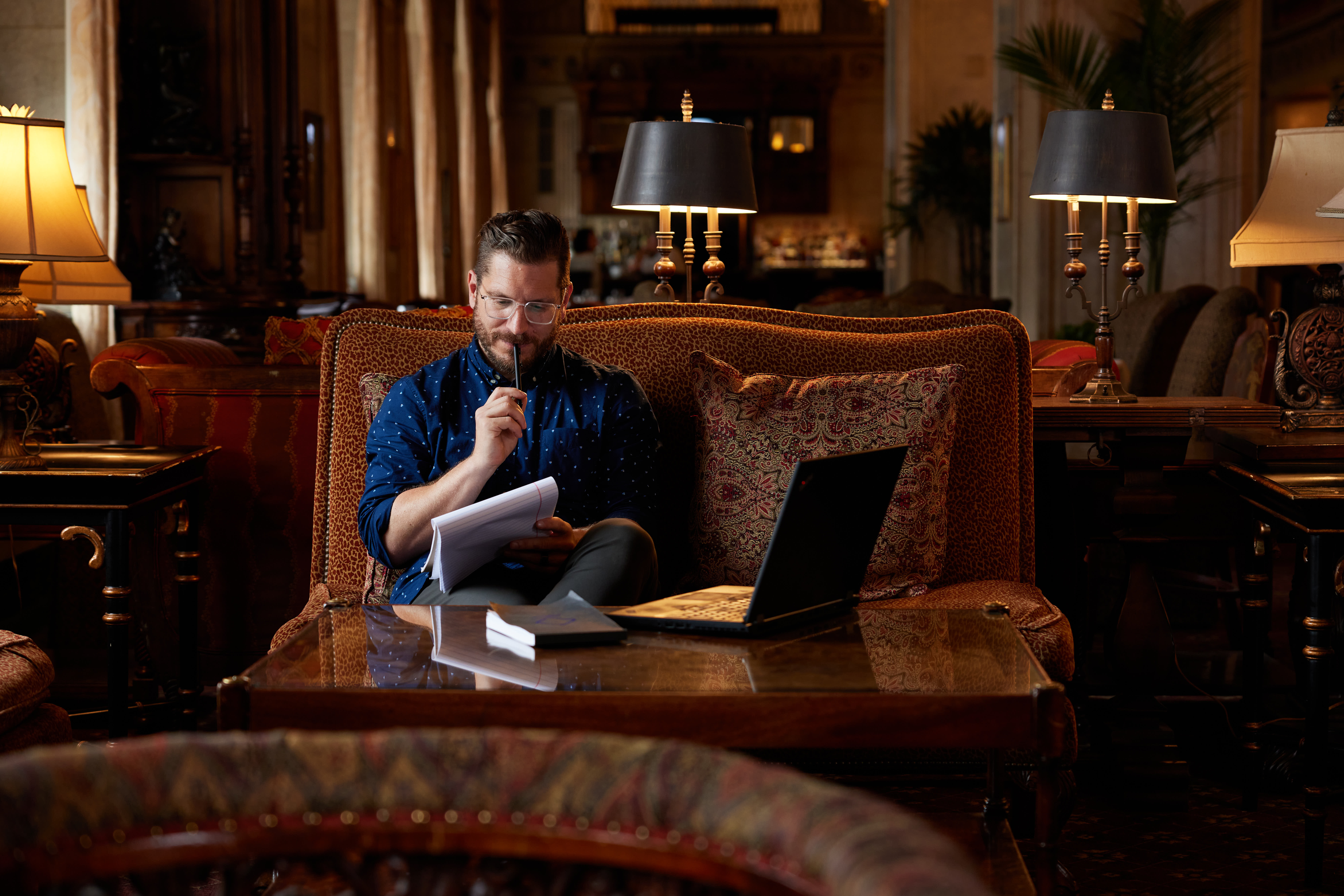Spalding MFA Student in Brown Hotel holding pen and notepad