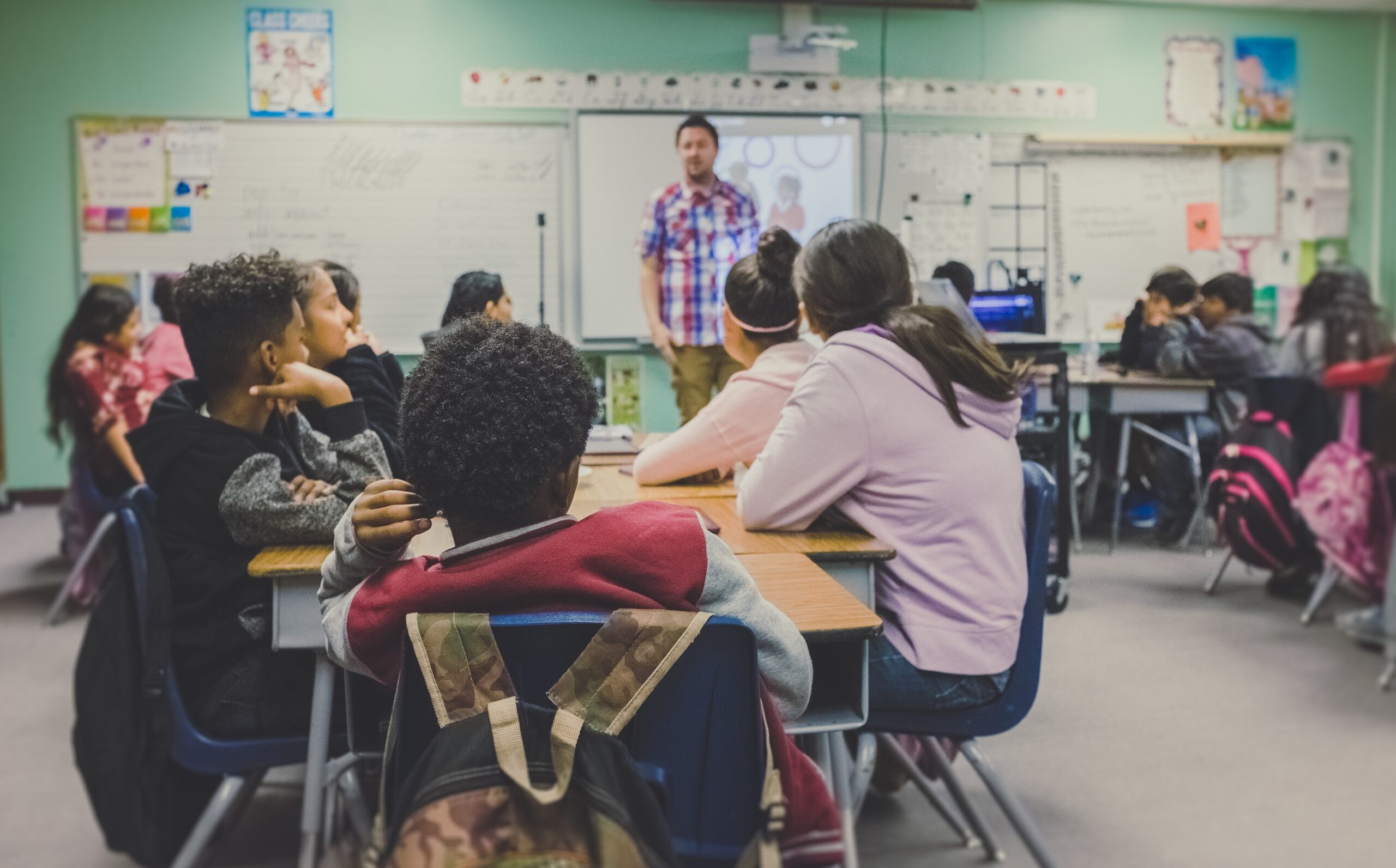Students and teacher in middle school class room