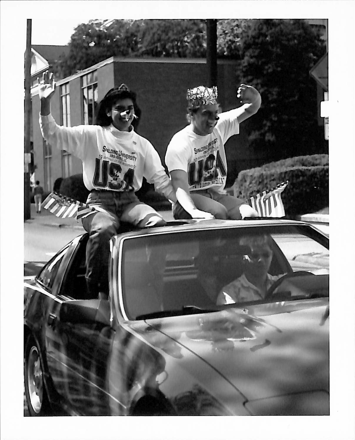 Mr. & Ms. Rodent waving from car during parade
