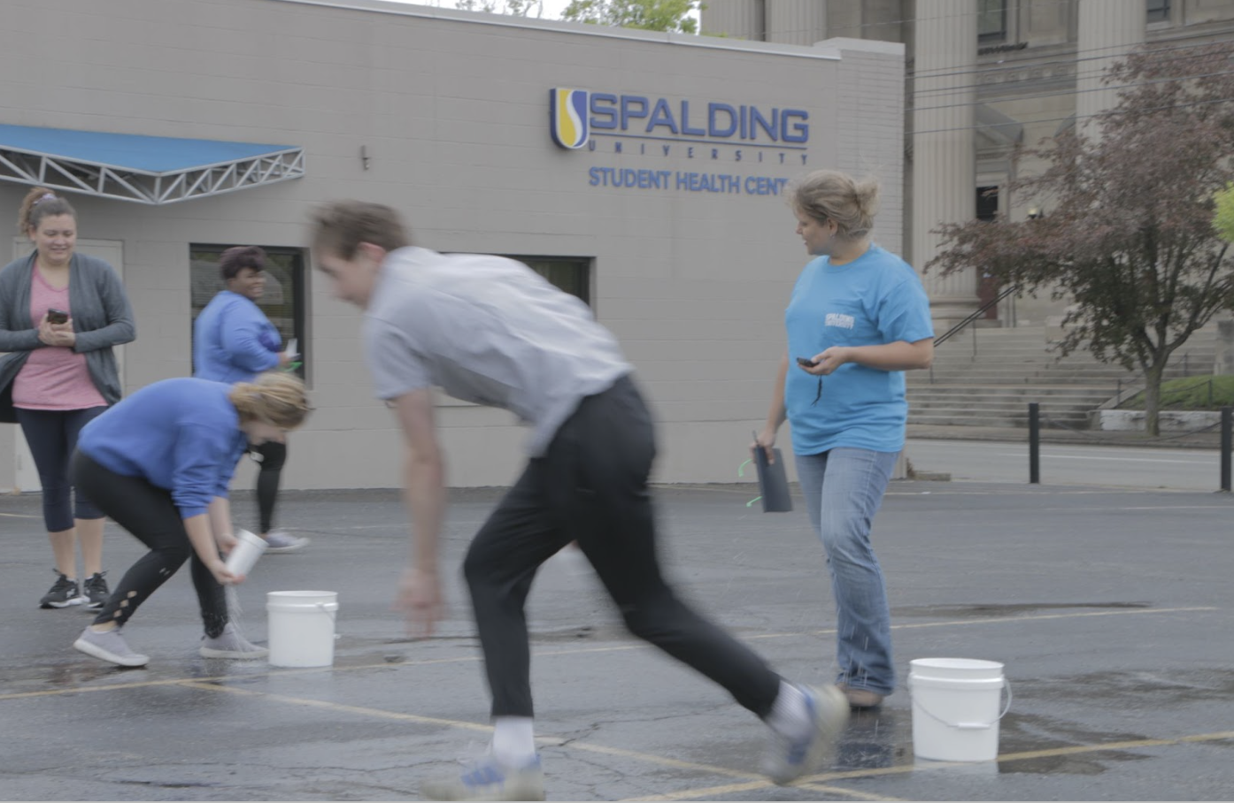 Spalding students running through rat race obstacle course