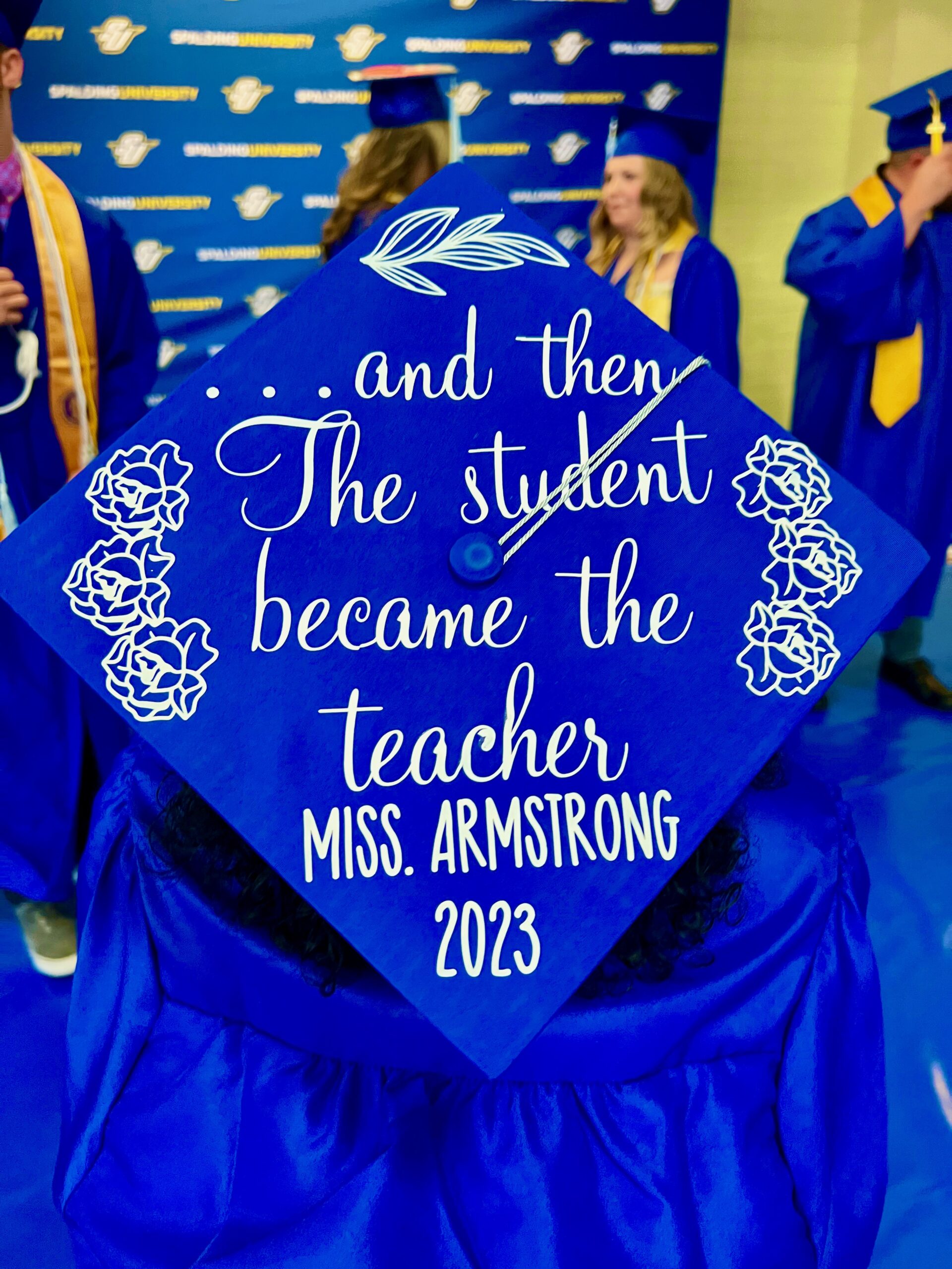Decorated mortarboard reading "... and then the student became the teacher. Miss Armstrong 2023"