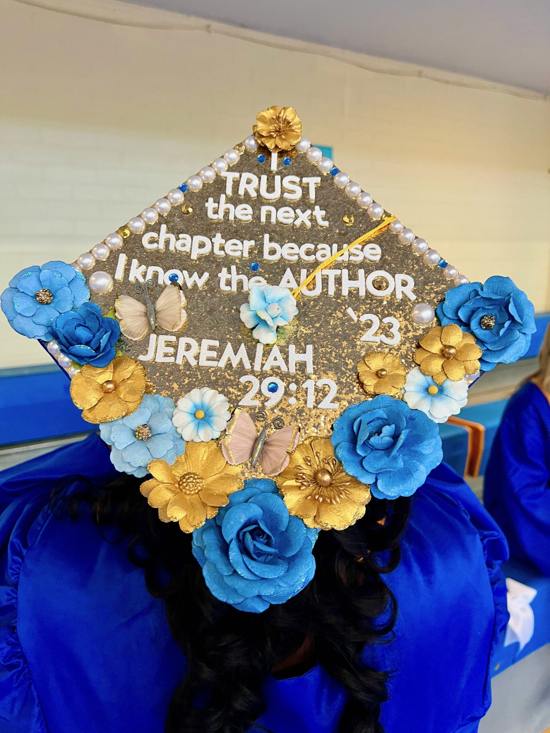 Decorated mortarboard reading "I trust the next chapter because I know the author. '23 Jeremiah 29:12"