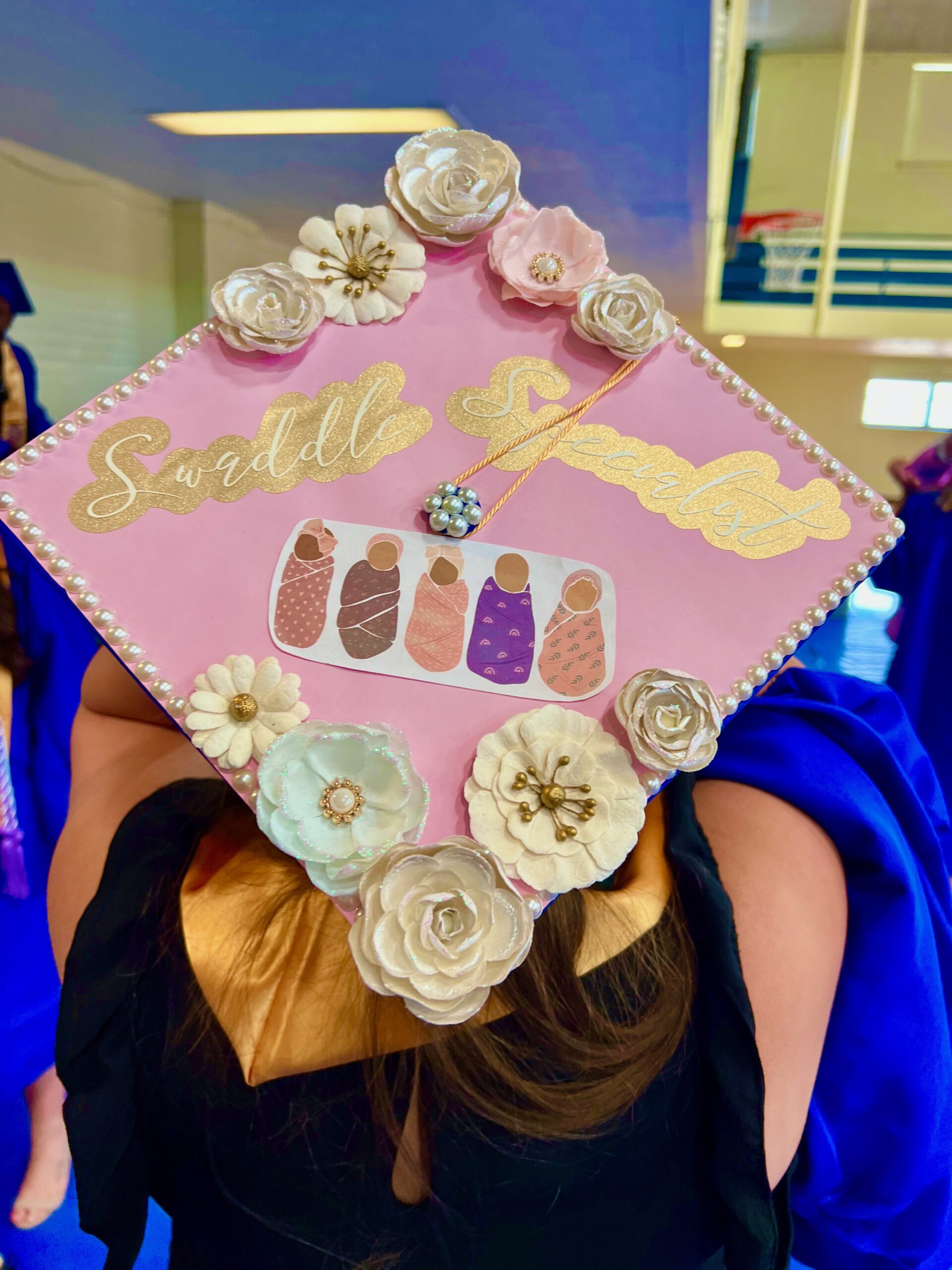 Decorated mortarboard reading "Swaddle Specialist"