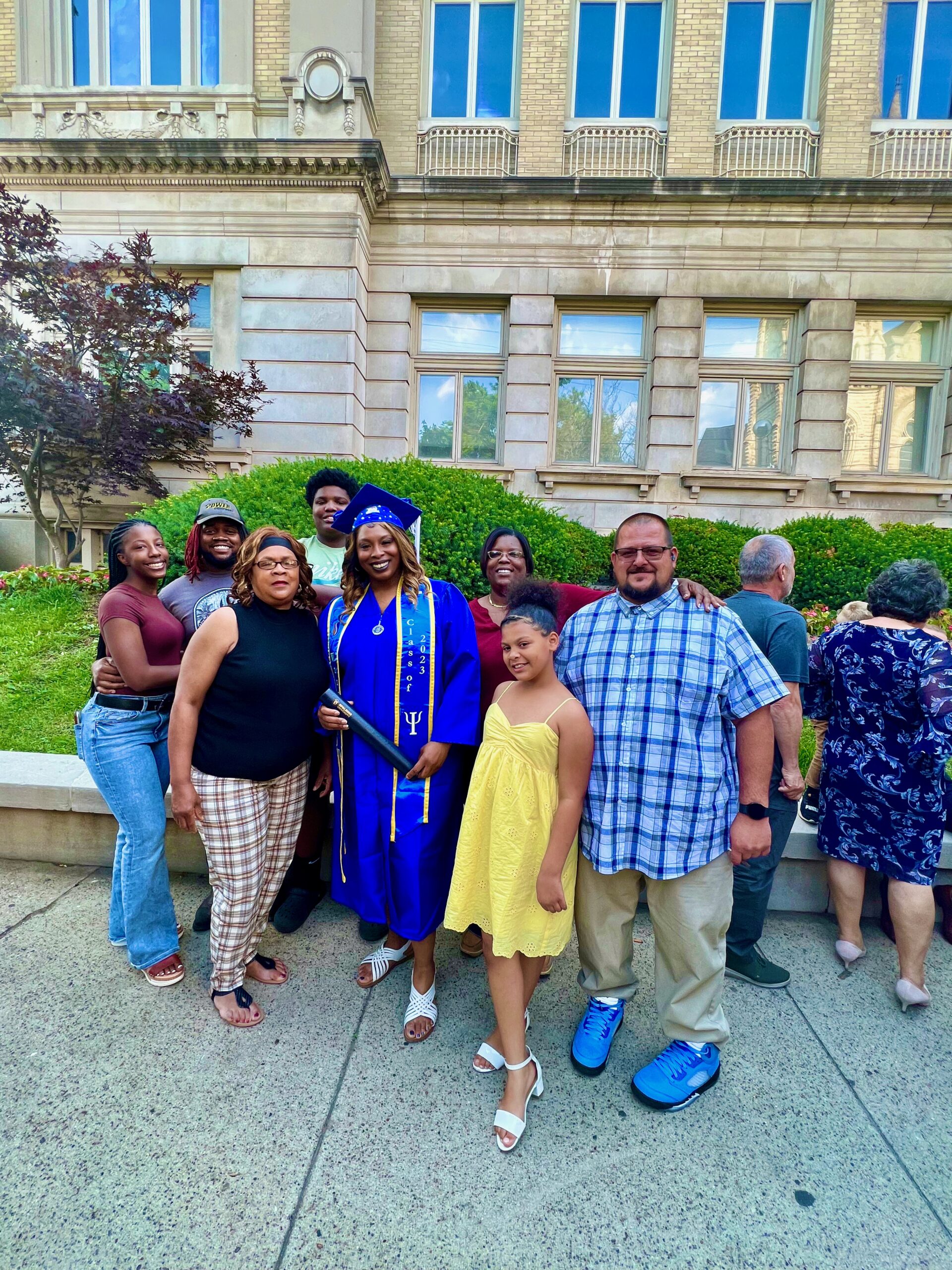Spalding bachelor's graduate posing with family for photo outside