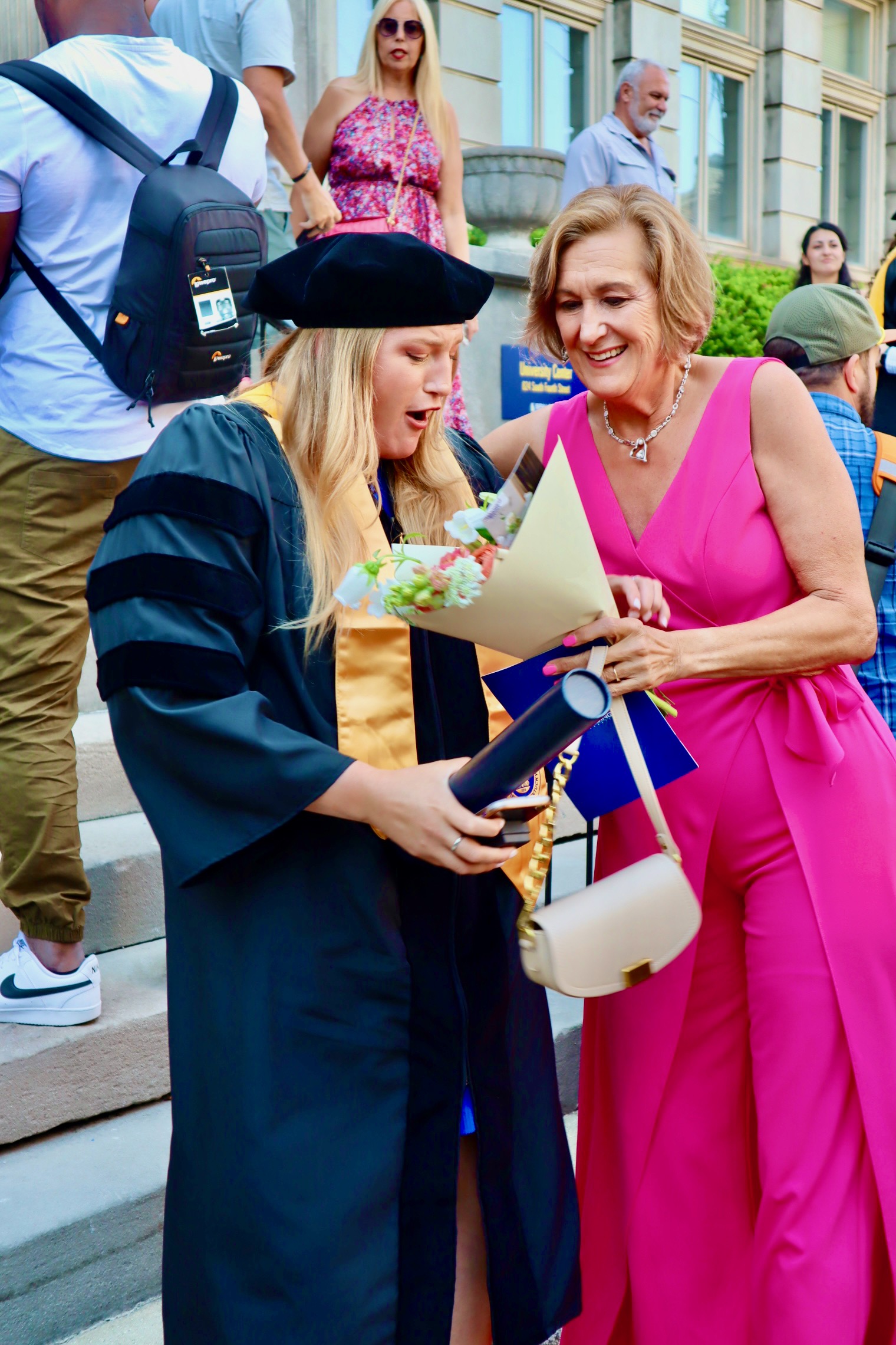 Spalding Doctoral graduate getting flowers from mom