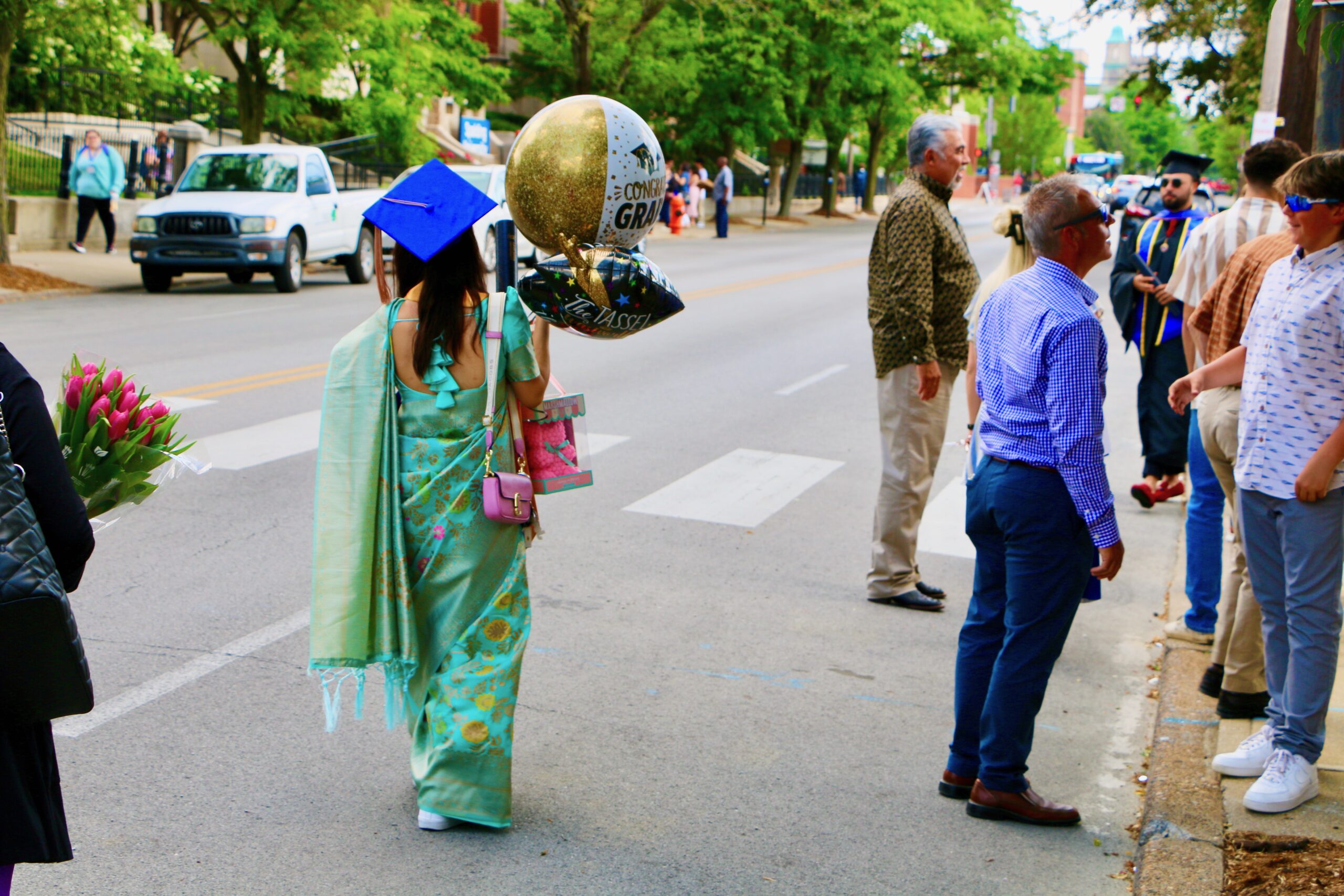 Spalding bachelor's graduate walking away with balloons