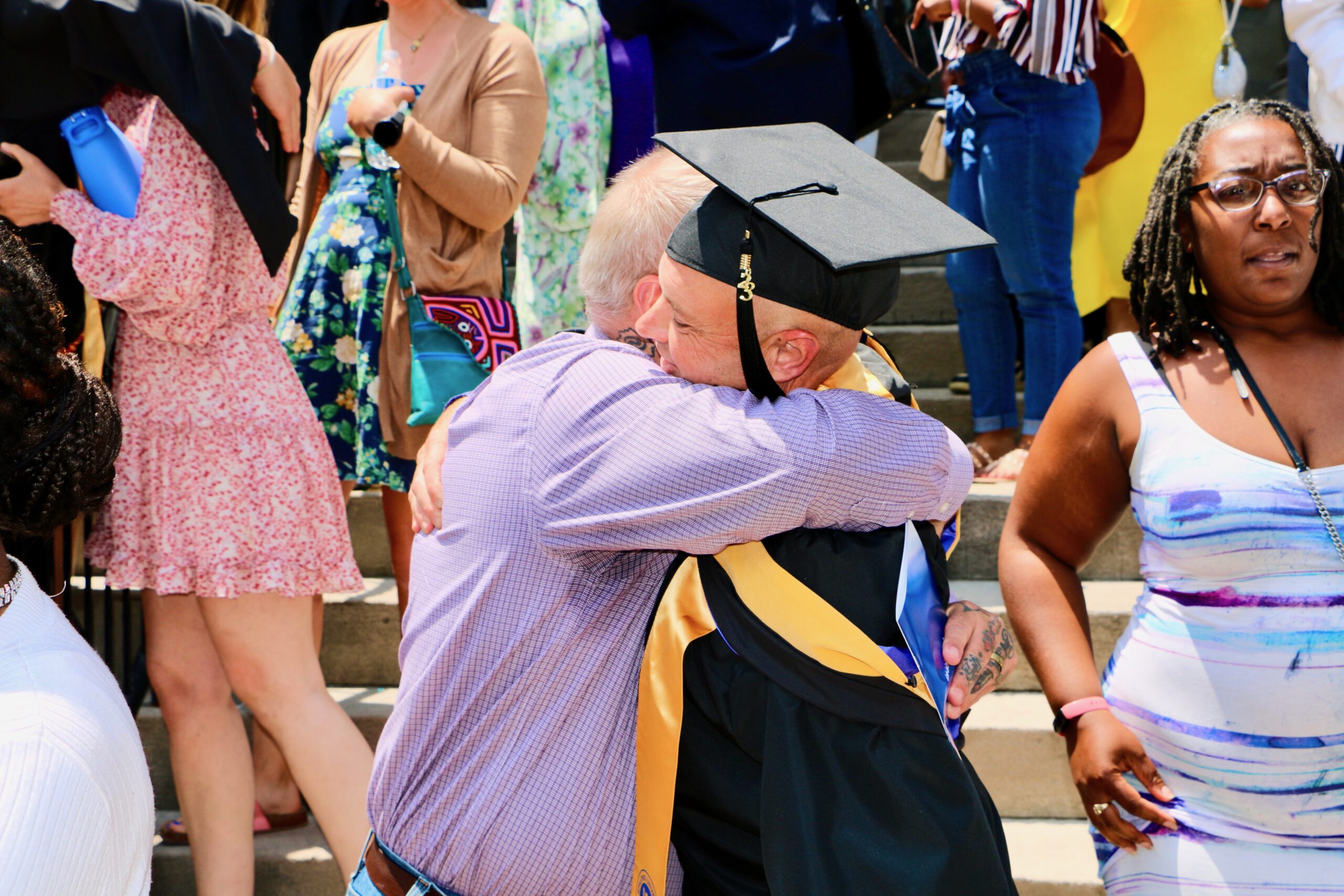 Spalding master's graduate and their dad hugging outside