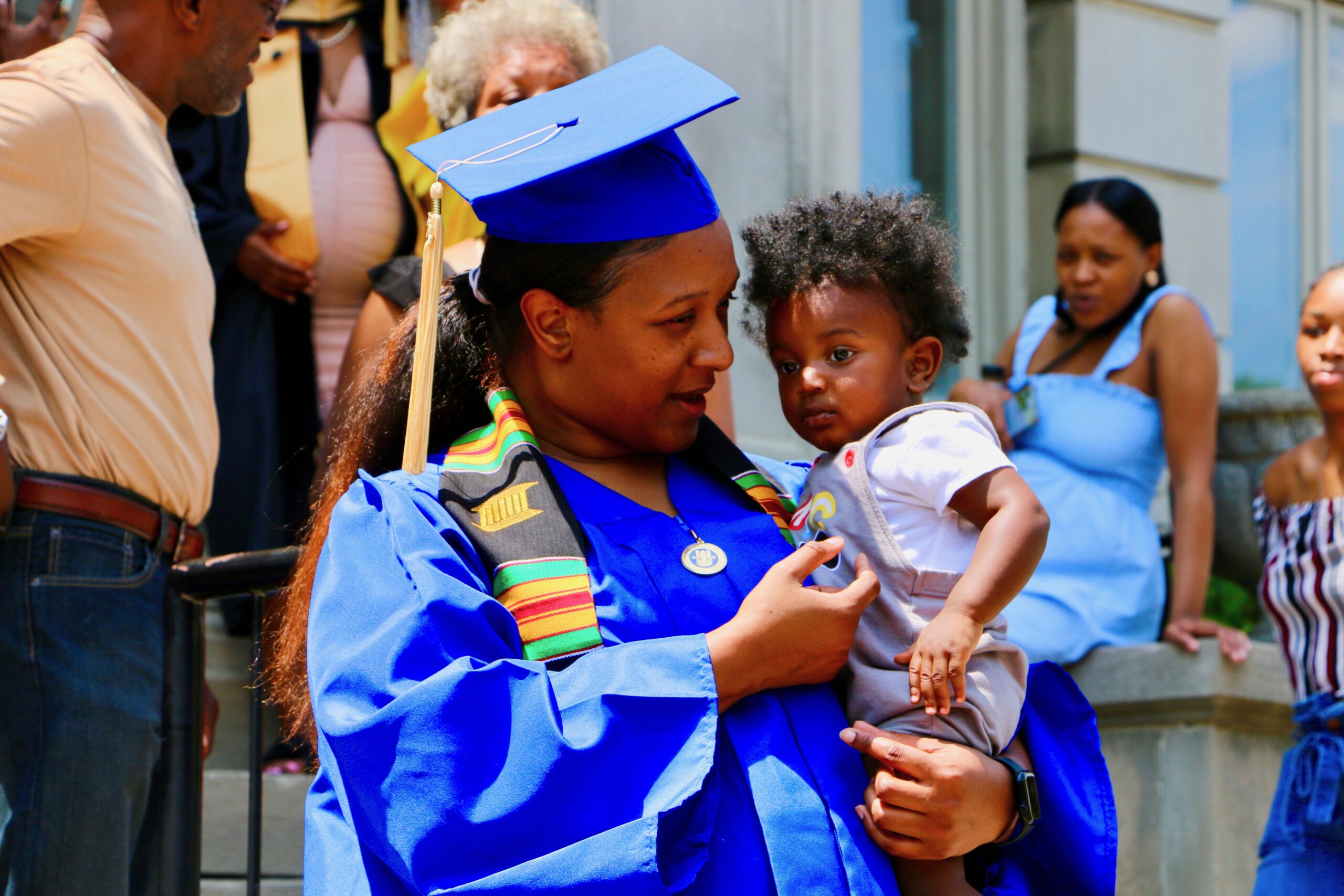 Spalding bachelor's graduate holding her young child