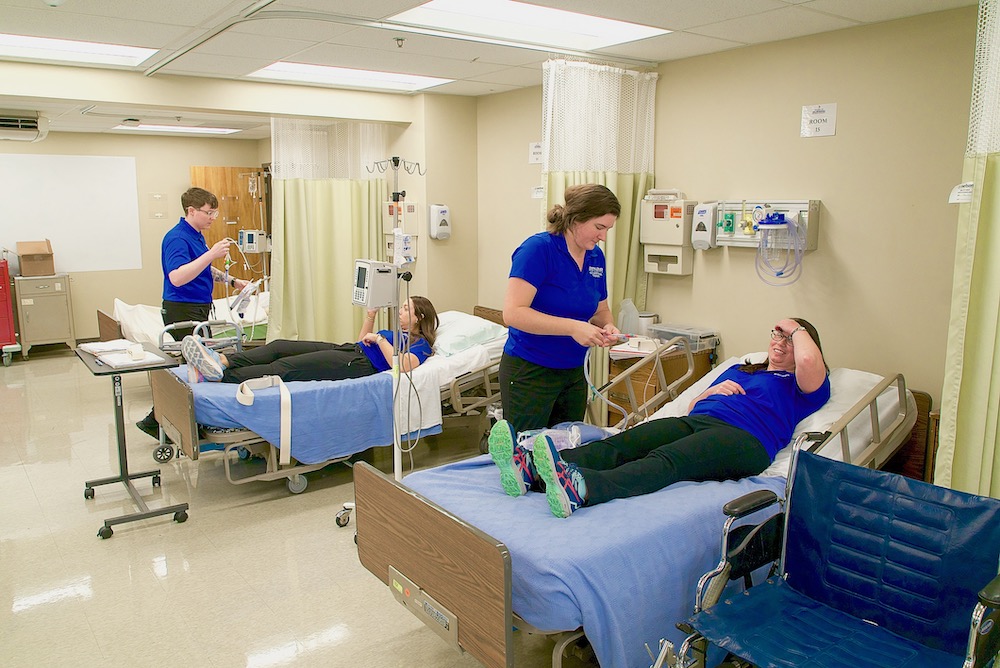 OTD students practicing on each other in the simulation lab.