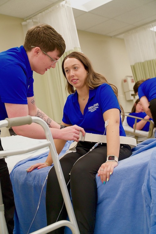 Spalding University occupational therapy students practicing with medical equipment in simulation lab.