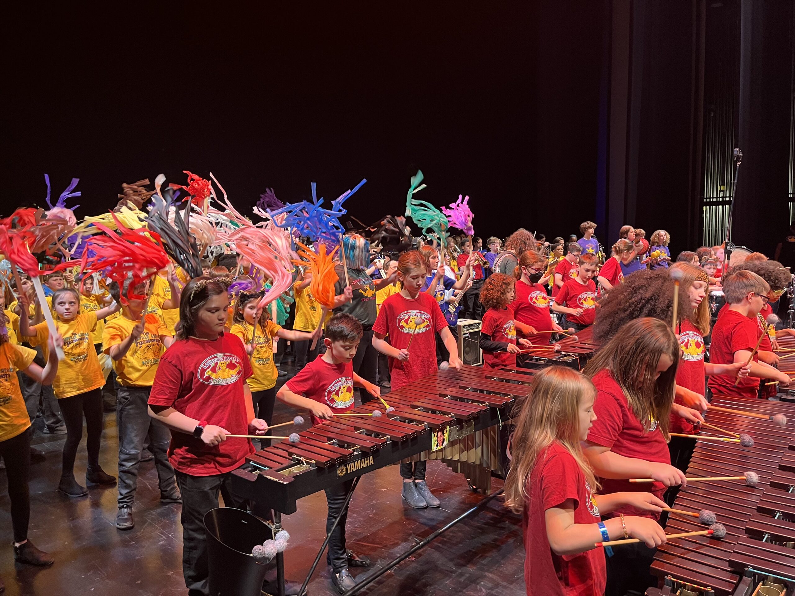 Louisville Leopards Percussionists performing in an auditorium.