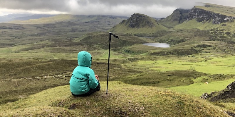 Boy in green coat on the top of the Isle of Skye.