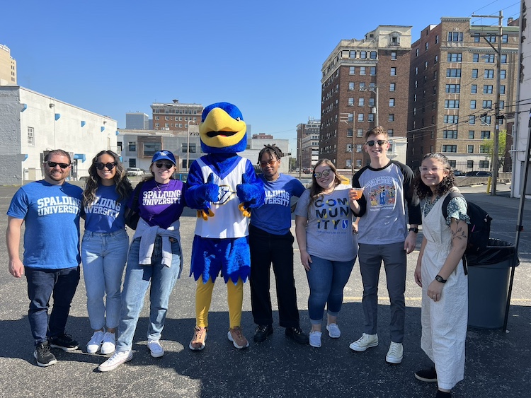 Spalding admissions team and students posing for picture with Ollie the Eagles