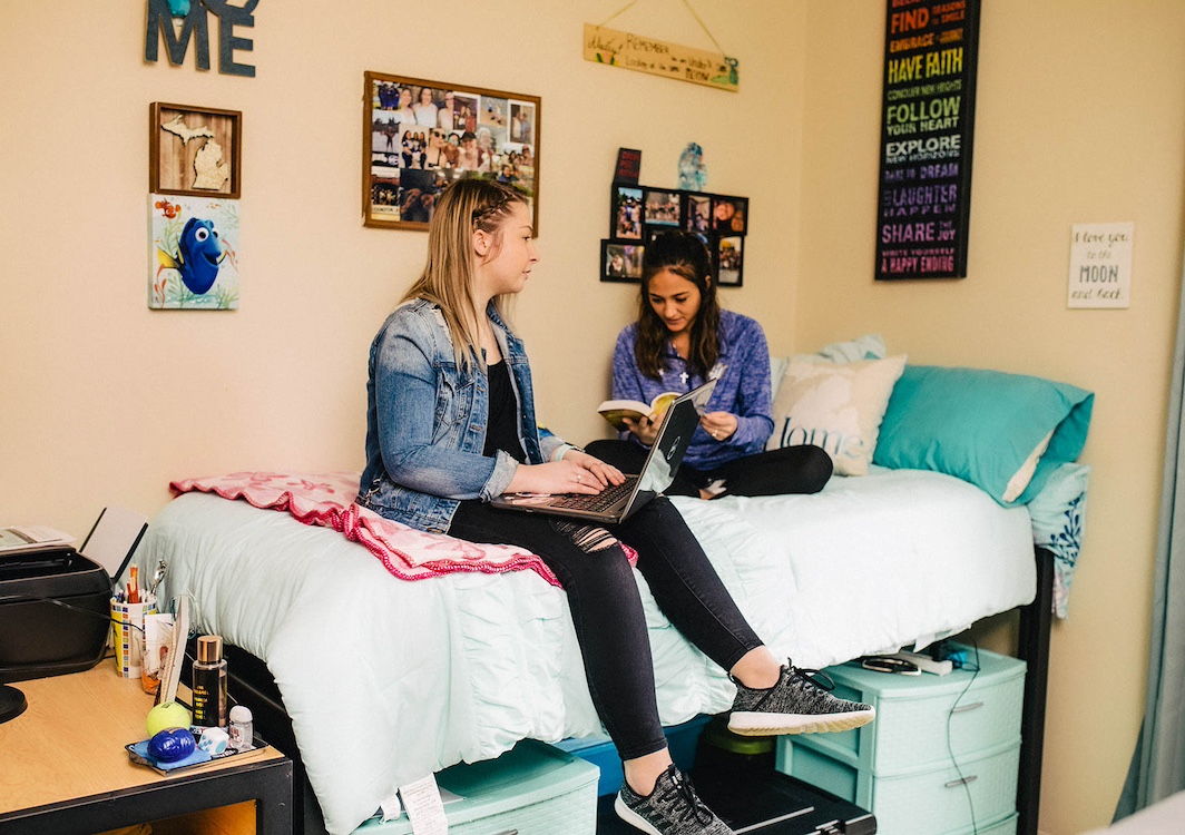 Two Spalding students study in dorm room