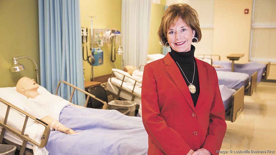 Joanne Berryman in Simlab, standing in front of beds with test dummies. Image courtesy of Louisville Business First