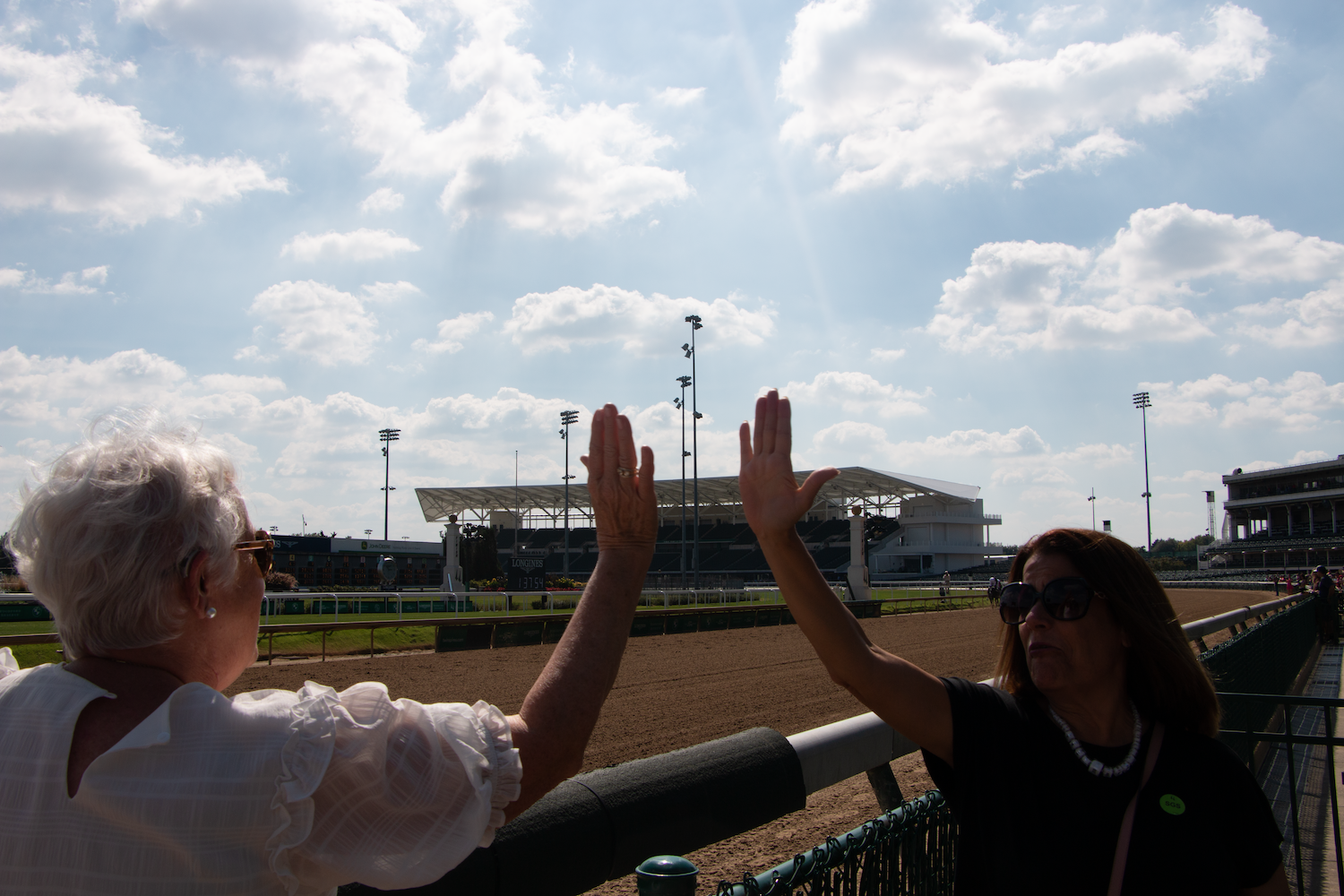 Spalding alumni high-fiving at Day at the Downs