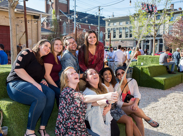 Group of Spalding students taking a photo with a selfie stick.