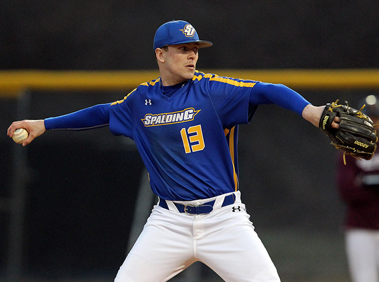 Spalding baseball player in uniform mid-pitch.