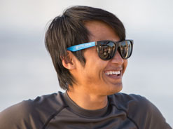 Male Spalding student wearing sunglasses and smiling.