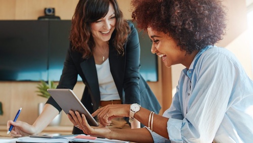 Two people looking at tablet while collaborating on a project